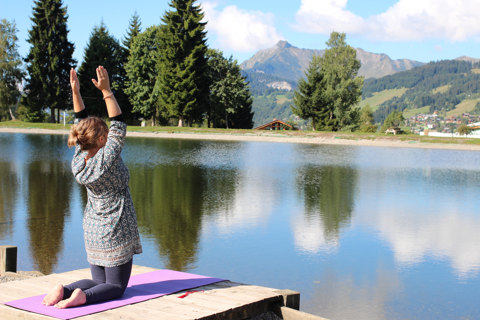 Woman doing yoga by the lake