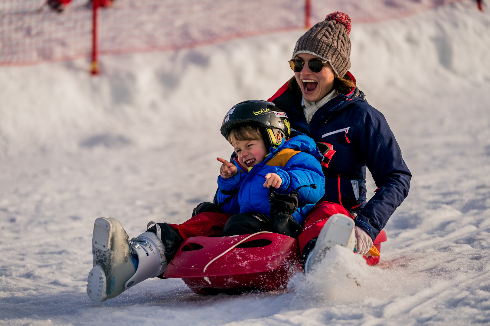 Maman et son enfant faisant de la luge ensemble