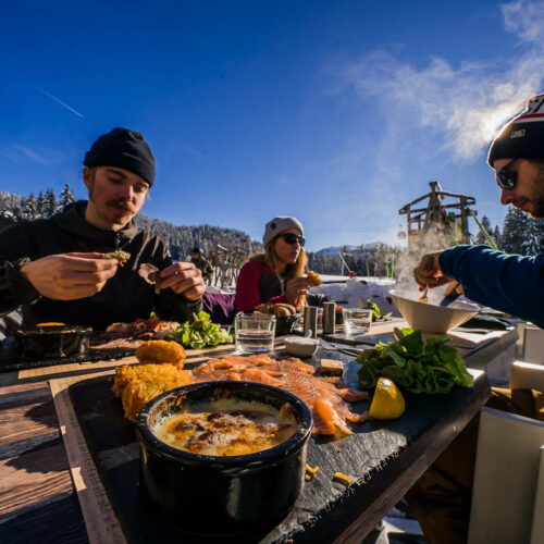 Amis prenant un repas au restaurant en terrasse en hiver