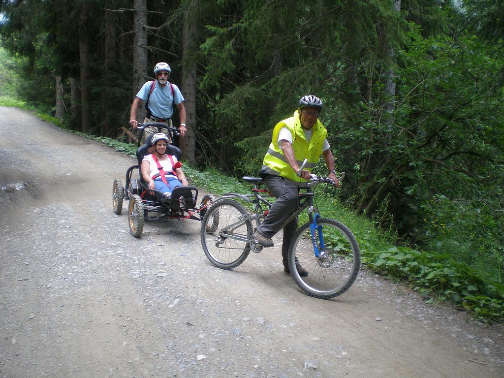 Three people riding MTBs, two of whom are Handi MTBs